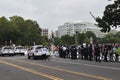 Police officers, police cars and DC municipal trucks serve as a barrier on Third Street next to the Justice of J6 Protest
