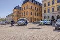 Police officers standing by their patrol cars, ensuring law and order on central square. Stockholm.