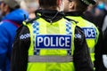 3 police officers in yellow vests watching the big screen Royalty Free Stock Photo