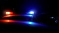 Police patrol car with flashing lights during night raid against crime on street Royalty Free Stock Photo