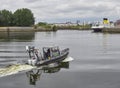 A Police Patrol Vessel moves away from the side of the River Bank and into the River Clyde at Glasgow`s Pacific Quay.