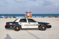 Police pays attention at famous south beach sunset in Miami Beach with lifeguard tower in background