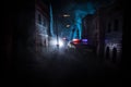 Police raid at night and you are under arrest concept. Silhouette of handcuffs with police car on backside. Image with the