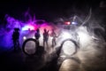 Police raid at night and you are under arrest concept. Silhouette of handcuffs with police car on backside. Image with the