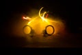 Police raid at night and you are under arrest concept. Silhouette of handcuffs with police car on backside. Image with the
