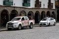 Police Rescue Vehicle and a Taxi in Plaza Mayor de Cusco (Cusco Main Square). Cusco, Peru, October 7, 2023.