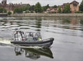 A Police river Boat patrols around Pacific Quay on the River Clyde at Glasgow