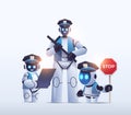 police robots patrol cops in uniform standing together artificial intelligence technology concept Royalty Free Stock Photo