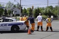 Police and security crew in the middle of the road watching coming city parade