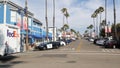 Police sheriff car, Pier View Coffee cafe. FedEx truck van on crossroad. Oceanside, California USA Royalty Free Stock Photo