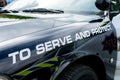 Police sign on police patrol car.