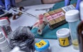 Police specialist examines piece of cloth stained with blood belonging to the victim of murder