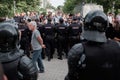 Police stand in a cordon at an unsanctioned opposition rally. Su