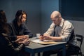 At the police station, two officers are interrogating the captured criminal Royalty Free Stock Photo