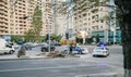 Police surveilling central Baku street with cars apartment buildings