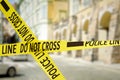 Yellow police tape isolating crime scene. Blurred view of city street Royalty Free Stock Photo