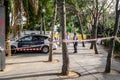 Police tape wrapped around a tree to limit the perimeter of a crime scene or a suspected bomb site. 03.01.2020 Barcelona, Spain