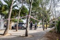 Police tape wrapped around a tree to limit the perimeter of a crime scene or a suspected bomb site. 03.01.2020 Barcelona, Spain