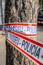 Police tape wrapped around a tree to limit the perimeter of a crime scene or a suspected bomb site. 03.01.2020 Barcelona, Spain