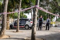 Police tape wrapped around a tree to limit the perimeter of a crime scene or a suspected bomb site. 03.01.2020 Barcelona, Spain