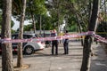 Police tape wrapped around a tree to limit the perimeter of a crime scene or a suspected bomb site. 03.01.2020 Barcelona, Spain