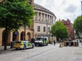 Police vehicles parked at the road side behind Manchester central library building, Manchester UK October 19 2023 Royalty Free Stock Photo