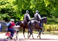 Police woman on horseback on The Mall, street in front of Buckingham Palace in London Royalty Free Stock Photo