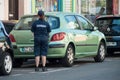 Police woman writing a minutes for a parked car Royalty Free Stock Photo