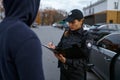 Police woman officer issuing fine to offender