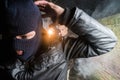 Policeman aiming pistol towards busted masked gangster at night Royalty Free Stock Photo