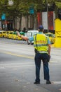 Policeman in australia, Melbourne is controlling traffic. Back view of an australian traffic police stopping cars with his hand