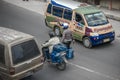 A policeman and biker on busy street in Sumatra.