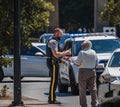 Policeman in a car accident scene dealing with a old man.Policeman interrogating an old man regarding the car accident Royalty Free Stock Photo