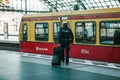 Berlin, October 03, 2017: A policeman with the chieftain goes to the train to leave. Demobilization, vacation.