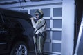 Policeman With Flashlight Investigating Car In Garage Royalty Free Stock Photo