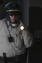 Policeman With Flashlight Patrolling At Night