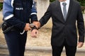 Policeman french handcuffs police officer arresting to man Royalty Free Stock Photo