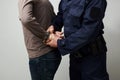 Policeman handcuffing an illigal man. Royalty Free Stock Photo