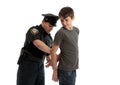 Policeman handcuffing teenager Royalty Free Stock Photo
