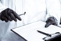 A policeman looks through a magnifying glass at the evidence at the crime scene. The crime scene of poisoning and overdosing