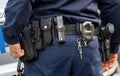 Policeman, police equipment utility belt with a gun, pepper spray and various accessories, detail shot, closeup seen from behind Royalty Free Stock Photo