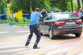 A policeman, a road policeman in a blue uniform, fights, delays, arrests a criminal driver of a car. Belarus, Minsk, 08.08.2018.