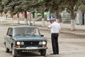 A policeman shows the driver the direction in bypass is closed f