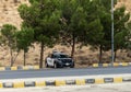 A policeman sits in a police car on the side of the road and monitors traffic safety near Wadi Rum in Jordan Royalty Free Stock Photo