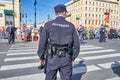 Policeman stands with his back to the camera. Police lettering on the jacket