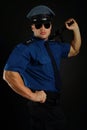 Policeman with sunglasses in uniform poses. Royalty Free Stock Photo