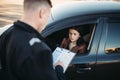 Policeman in uniform writes fine to female driver Royalty Free Stock Photo