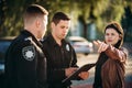 Policeman write testimony of female driver Royalty Free Stock Photo