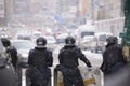 Policemen shields helmets blocking Khreshchatyk street during mass protest, blurred cars on a background. Revolution of