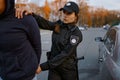 Policewoman arresting man car thief on road Royalty Free Stock Photo